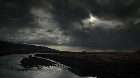 Sun through storm clouds over glacial river mountain valley Iceland HDR  Stockbeeldmateriaal 110822727