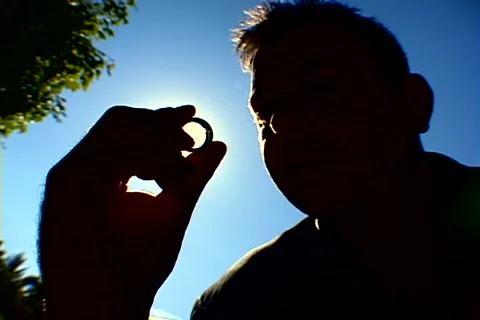 Sun through a wedding ring Stock Footage 937454