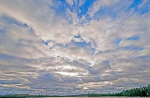 Sun trying break through cumulus clouds Photos