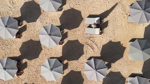 Sun umbrellas at the empty beach at morning time, Drone point of view. Stock Footage 311942931