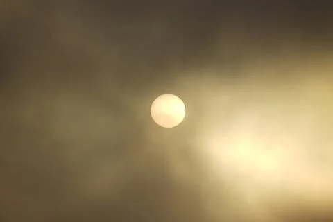 Sun view through thick clouds. Stock Photos