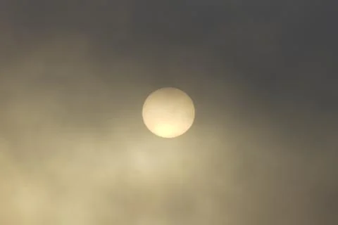 Sun view through thick clouds. Stock Photos
