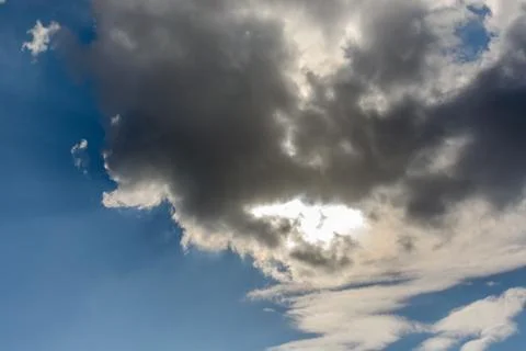 The sun was hidden by clouds in the blue sky Stock Photos