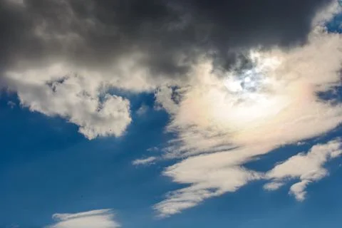 The sun was hidden by clouds in the blue sky Stock Photos