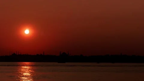 The sun was setting in a blaze of hot, fiery glory, casting long shadows across Stock Footage 246479665