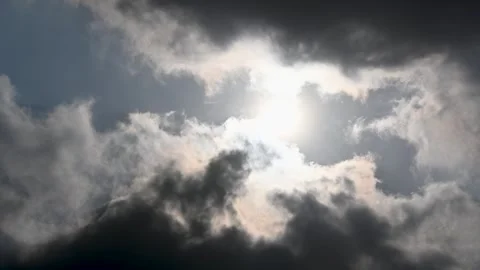 The sun was sometimes covered and sometimes revealed by fast-moving clouds. Stock Footage 253191834