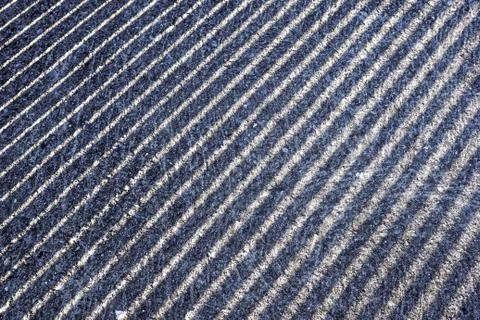Sun White lines flow on black asphalt. The white lines against the black asphalt Stock Photos