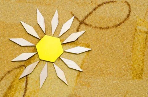 The sun from a wooden constructor on the carpet Stock Photos