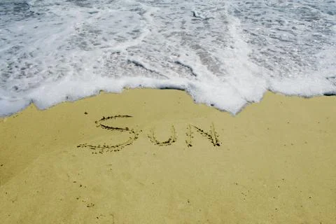 Sun written in the sand Stock Photos