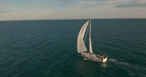 Sun yachts with white sails in open sea aerial. Sailing seascape at summer sunny Stock Footage 151377378