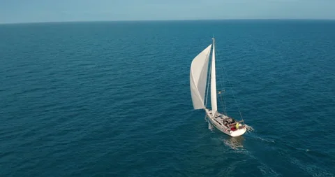 Sun yachts with white sails in open sea aerial. Sailing seascape at summer sunny Vídeo Stock 151445920