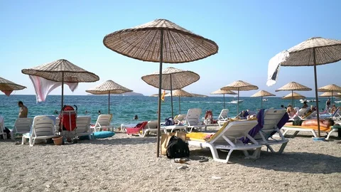 Sunbathers by the sea Stock Footage 125476852