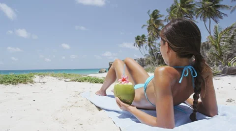 Sunbathing bikini woman lying down tanning relaxing on tropical beach holiday Stock Footage 62323184