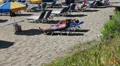 Sunbathing people on Coral Bay beach in Paphos, Peyia, Cyprus HD Footage