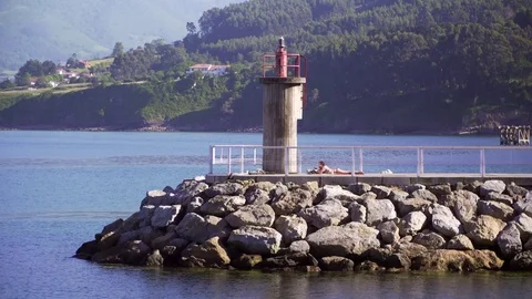 Sunbathing on the pier in the harbor. Stock Footage 69942345