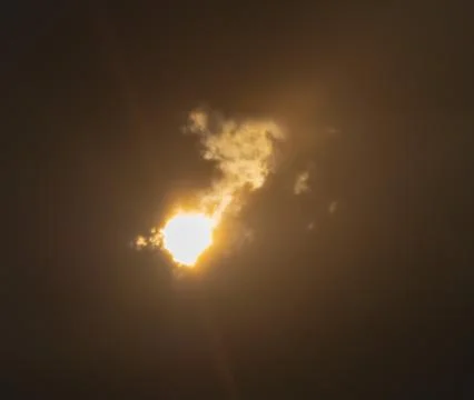 Sunbeam behind clouds Stock Photos