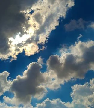 Sunbeam behind dark clouds Stock Photos