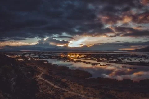 Sunbeam from dark clouds over Titicaca lake Stock Photos