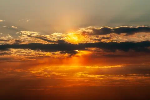 Sunbeam of light breaks through thunderclouds during sunset Stock Photos