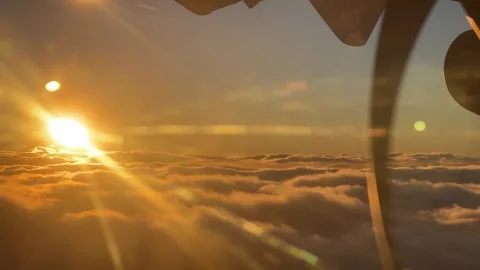 Sunbeam piercing through clouds as seen from airplane window Stock Footage 267658795