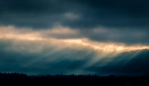 Sunbeam through the clouds after a thunderstorm Stock Photos