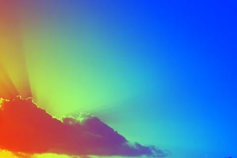 Sunbeams above the clouds. Sun shining through the clouds with sunbeams. Stock Photos