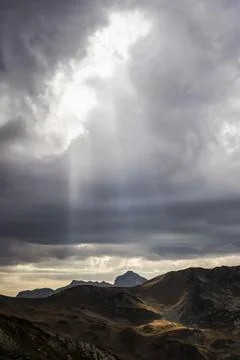 Sunbeams are seen through cloudy sky in Caucasus national park Stock Photos