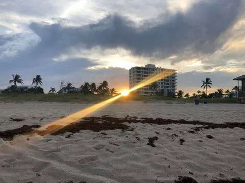 Sunbeams on the beach at sunset Stock Photos