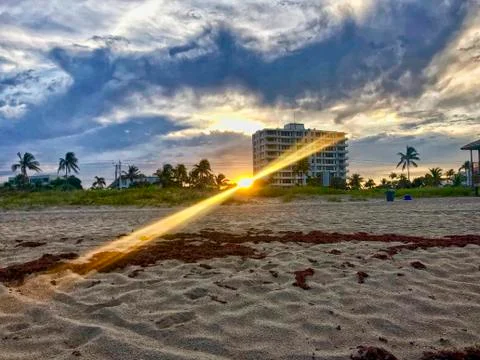 Sunbeams on the beach at sunset Stock Photos