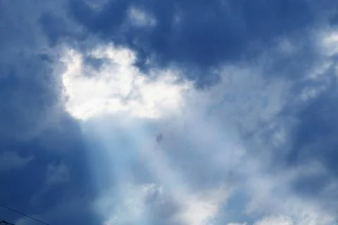 Sunbeams between dark thunderclouds Stock Photos