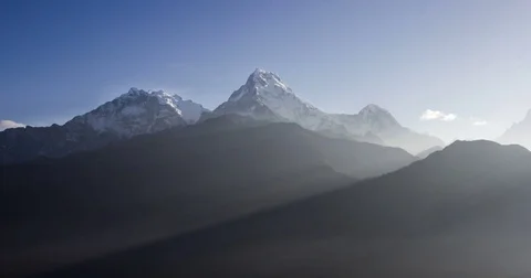Sunbeams between mountains at sunrise Stock Footage 79605371