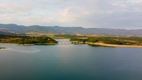 Sunbeams breaking through clouds over tuscan lake Stock Footage 320860918