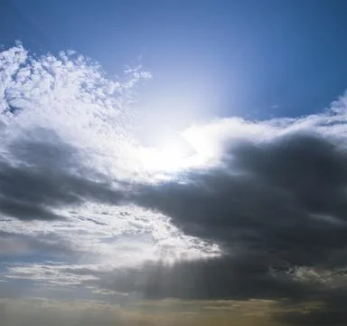 Sunbeams breaking through the dark clouds. Only sky, no land view. Foto stock