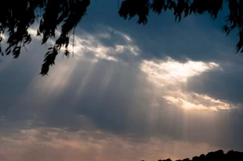 Sunbeams come out of the clouds. Stock Photos