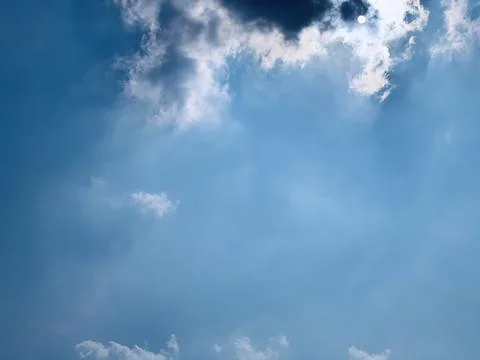 Sunbeams Emerging Through Dramatic Clouds in a Blue Sky Stock Photos