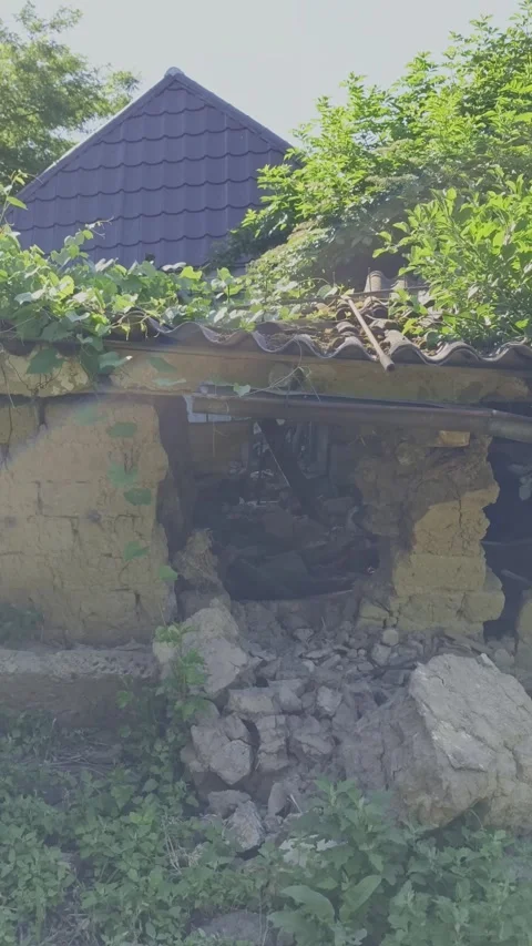 Sunbeams filter through a ruined, collapsing traditional mudbrick house Stock Footage 337483645