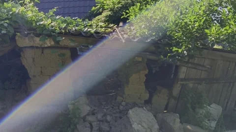 Sunbeams filter through a ruined, collapsing traditional mudbrick house Video stock 337545352