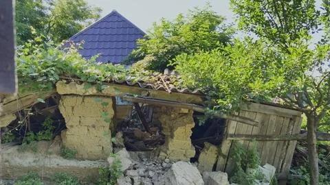 Sunbeams filter through a ruined, collapsing traditional mudbrick house Stock Photos