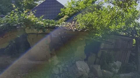 Sunbeams filter through a ruined, collapsing traditional mudbrick house Stock Photos