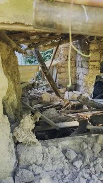 Sunbeams filter through a ruined, collapsing traditional mudbrick house Stock-Fotos
