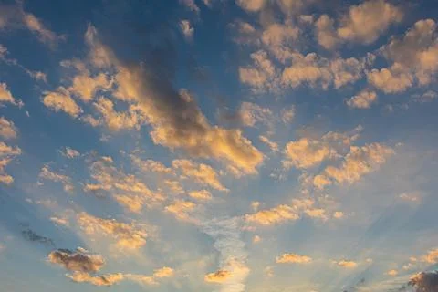 Sunbeams Light Up Clouds Against Cobalt Blue Sky At Dusk Stock Photos