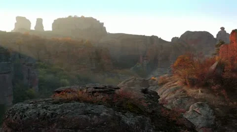Sunbeams lighten rock formation Stock Footage 21273066