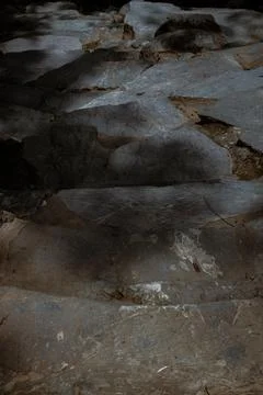 Sunbeams lighting down of stone slab at brookside. Stock Photos