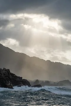 Sunbeams lighting up dramatic seascape in tayrona national park, colombia Stock Photos