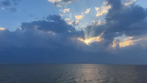 Sunbeams piercing through dark storm clouds over Erhai Lake China Stock Footage 333749388
