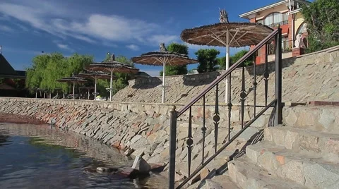 Sunbeams reflected from the transparent water playing on a beach umbrella. Video stock 63174096
