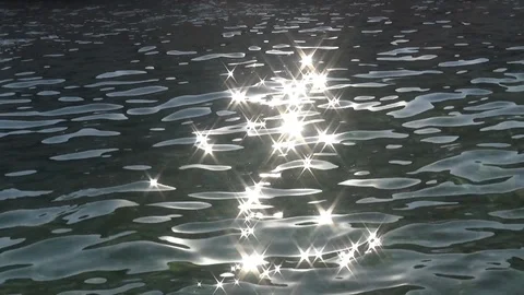 Sunbeams reflecting sea surface close up Video stock 127241630