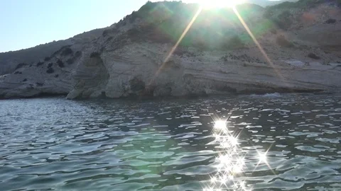 Sunbeams reflecting sea surface under the rock 스톡 동영상 127240698