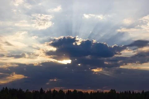 Sunbeams shining through clouds; beautiful natural secnery Stock Photos