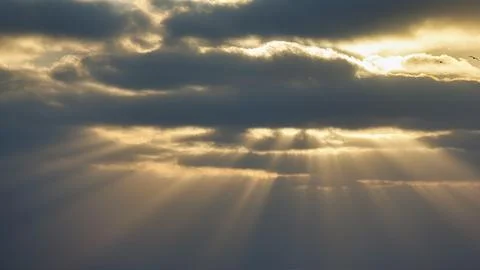 Sunbeams shining through clouds gap in clouds dramatic evening sky Algarve Stock Photos
